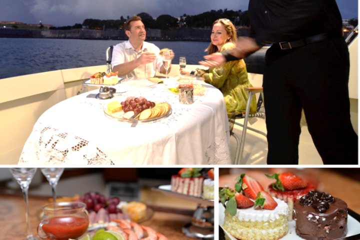 a group of people sitting at a table with a cake