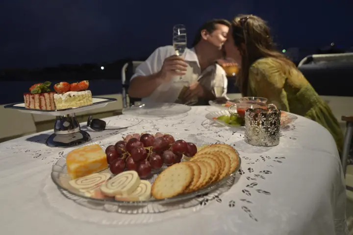 a woman sitting at a table with a plate of food